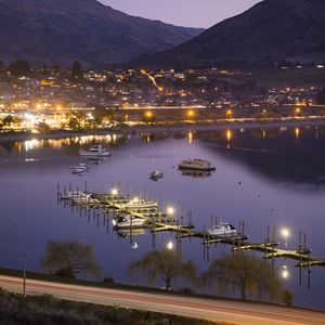 Preview wallpaper boats, pier, lights, mountains, twilight