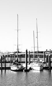 Preview wallpaper boats, pier, pilings, black and white