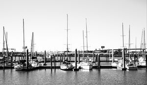 Preview wallpaper boats, pier, pilings, black and white