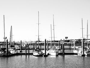 Preview wallpaper boats, pier, pilings, black and white