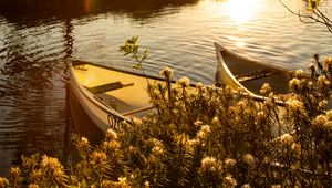 Preview wallpaper boats, river, rays, bushes