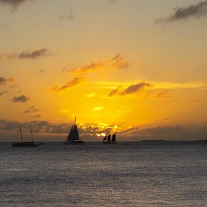 Preview wallpaper boats, ships, sails, silhouettes, sea, sunset