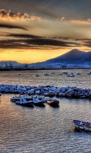 Preview wallpaper boats, vessels, sea, stones, mountains, sky, evening