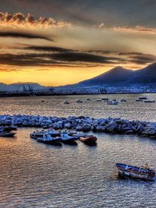 Preview wallpaper boats, vessels, sea, stones, mountains, sky, evening