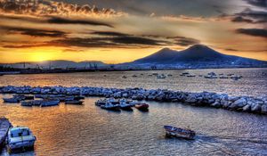 Preview wallpaper boats, vessels, sea, stones, mountains, sky, evening