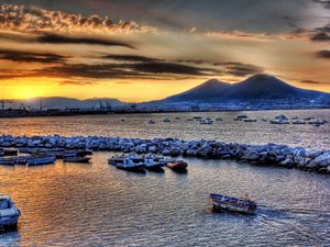 Preview wallpaper boats, vessels, sea, stones, mountains, sky, evening