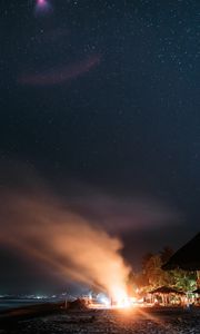 Preview wallpaper bonfire, beach, night, starry sky, smoke, palm trees, bright