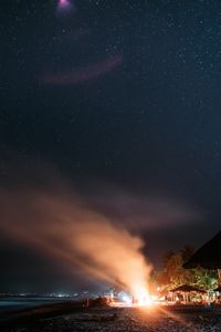 Preview wallpaper bonfire, beach, night, starry sky, smoke, palm trees, bright