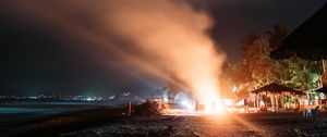 Preview wallpaper bonfire, beach, night, starry sky, smoke, palm trees, bright