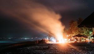 Preview wallpaper bonfire, beach, night, starry sky, smoke, palm trees, bright