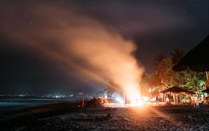 Preview wallpaper bonfire, beach, night, starry sky, smoke, palm trees, bright
