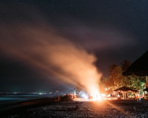 Preview wallpaper bonfire, beach, night, starry sky, smoke, palm trees, bright