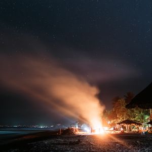 Preview wallpaper bonfire, beach, night, starry sky, smoke, palm trees, bright