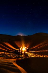 Preview wallpaper bonfire, camping, desert, people, night, starry sky, morocco