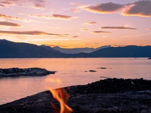 Preview wallpaper bonfire, fire, camping, sea, mountains, sunset