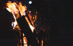 Preview wallpaper bonfire, fire, firewood, sparks, coal