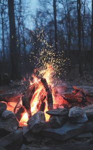 Preview wallpaper bonfire, fire, sparks, stones, firewood, burn