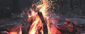 Preview wallpaper bonfire, fire, sparks, stones, firewood, burn