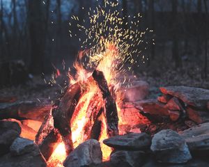 Preview wallpaper bonfire, fire, sparks, stones, firewood, burn