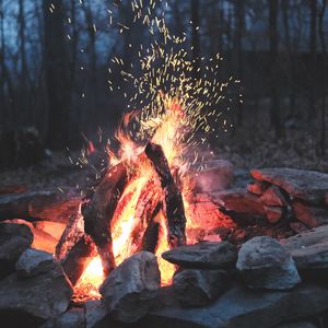 Preview wallpaper bonfire, fire, sparks, stones, firewood, burn