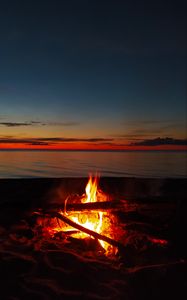 Preview wallpaper bonfire, flame, firewood, sunset, horizon