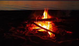 Preview wallpaper bonfire, flame, firewood, sunset, horizon