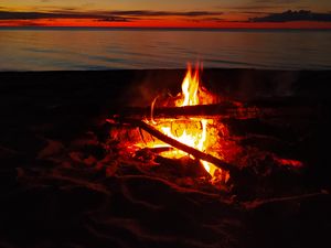 Preview wallpaper bonfire, flame, firewood, sunset, horizon