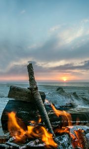 Preview wallpaper bonfire, flame, logs, coals, sunset