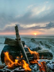 Preview wallpaper bonfire, flame, logs, coals, sunset