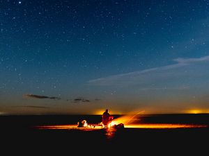 Preview wallpaper bonfire, silhouette, camping, starry sky, night