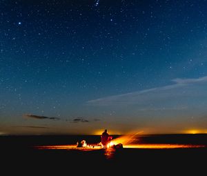 Preview wallpaper bonfire, silhouette, camping, starry sky, night