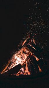 Preview wallpaper bonfire, sparks, fire, firewood, dark, darkness