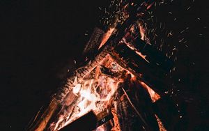 Preview wallpaper bonfire, sparks, fire, firewood, dark, darkness