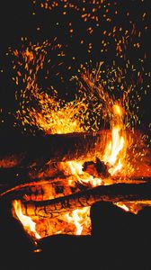 Preview wallpaper bonfire, sparks, logs, fire, black