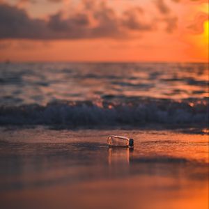 Preview wallpaper bottle, glass, sea, sunset, shore, blur