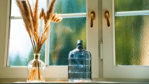 Preview wallpaper bottles, window, dried flowers, glass, bouquet, light, aesthetics