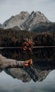 Preview wallpaper bouquet, flowers, hand, landscape, reflection