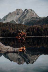 Preview wallpaper bouquet, flowers, hand, landscape, reflection