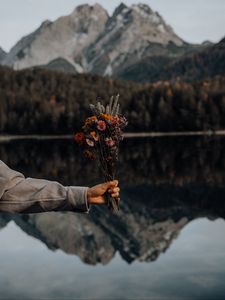 Preview wallpaper bouquet, flowers, hand, landscape, reflection