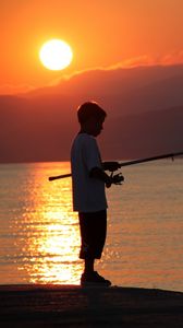 Preview wallpaper boy, river, lake, fishing, fishing rod, sunset, hills