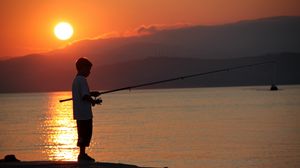Preview wallpaper boy, river, lake, fishing, fishing rod, sunset, hills