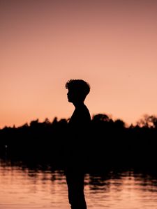 Preview wallpaper boy, silhouette, sunset, loneliness, water