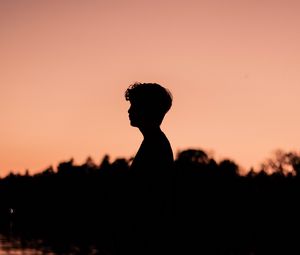 Preview wallpaper boy, silhouette, sunset, loneliness, water