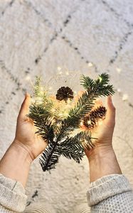 Preview wallpaper branch, garland, cones, hands, holiday, new year, christmas
