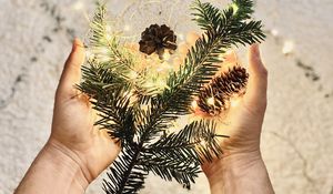 Preview wallpaper branch, garland, cones, hands, holiday, new year, christmas