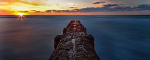Preview wallpaper breakwater, sea, skyline, sunset