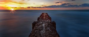 Preview wallpaper breakwater, sea, skyline, sunset