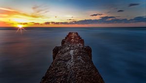 Preview wallpaper breakwater, sea, skyline, sunset