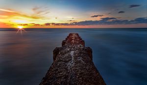 Preview wallpaper breakwater, sea, skyline, sunset