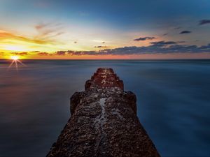 Preview wallpaper breakwater, sea, skyline, sunset